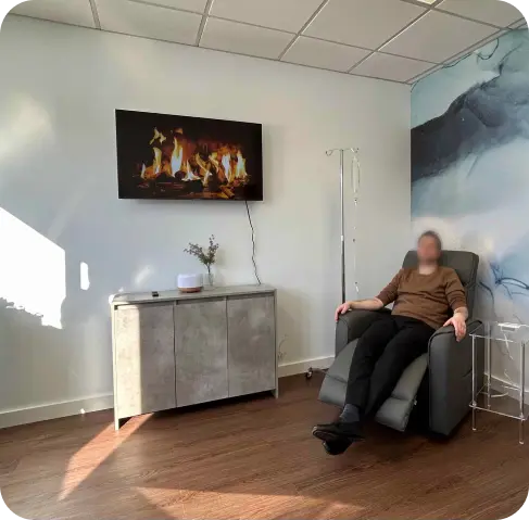 Patient relaxing in a recliner during IV therapy at Oasis Family Health