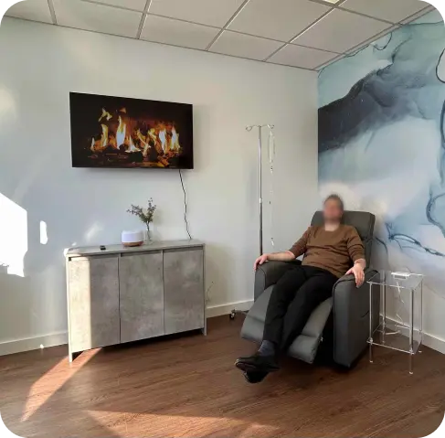 Patient receiving an infusion in a comfortable recliner at Oasis Family Health